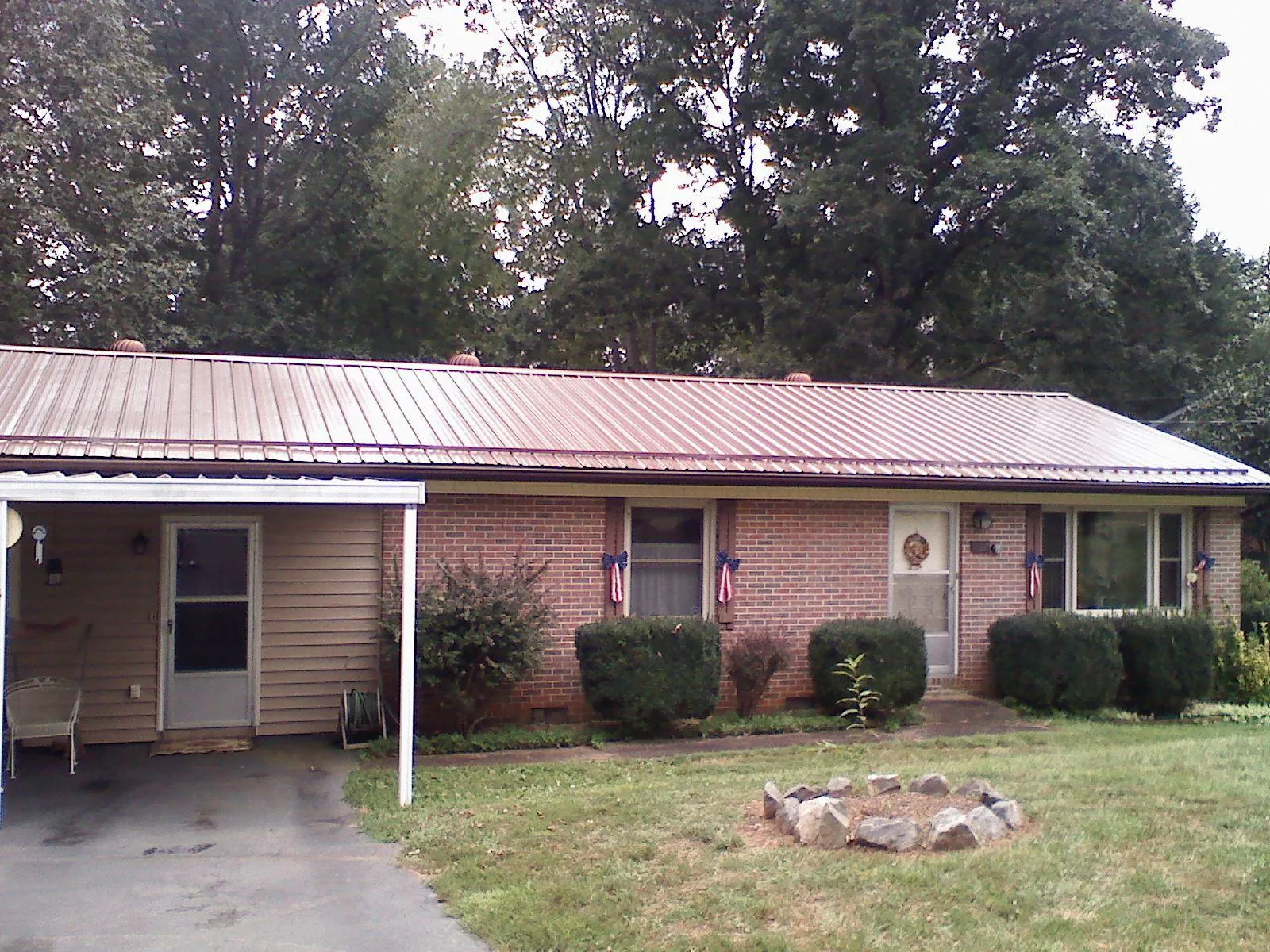 Bronze metal roof and carport on a brick ranch home — Roof Repair work by our crew in Everetts
