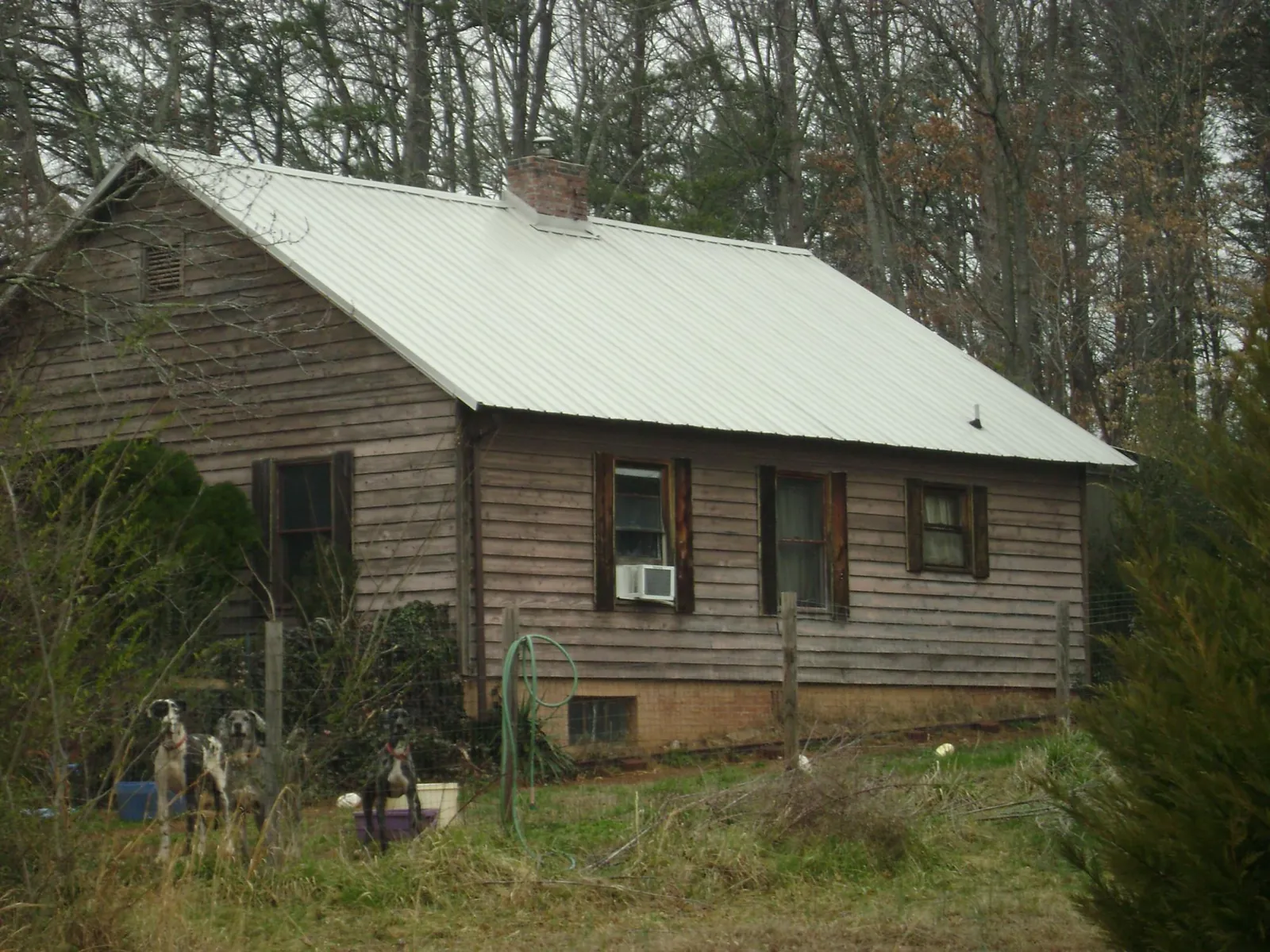 White metal roof on an old wood sided farmhouse, from a Metal Roof Installation job in Everetts
